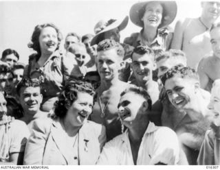 New Guinea. December 1943. Gladys Moncrieff chatting with patients at a base hospital. In the background are Kitty Bluett, Bebe Scott and Flo Paton, other members of her accomplished and popular ..