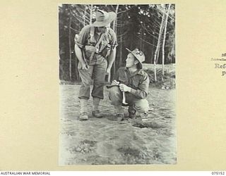 HANSA BAY-SEPIK RIVER AREA, NEW GUINEA. 1944-08-02. NX124564 LIEUTENANT D. FAIRALL, PLATOON COMMANDER, 30TH INFANTRY BATTALION (2) PREPARES TO SEND A MESSAGE TO THE UNIT OUT-POST ON THE SEPIK RIVER ..