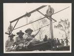 Servicemen crossing the Dunantina River using a pulley system while constructing a bridge on the Lae-Garoka Road, Eastern Highlands, Papua New Guinea, c1945 to 1946