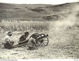 FORTIFICATION POINT, NEW GUINEA. 1944-04-06. A JAPANESE 75MM FIELD GUN, PACK TYPE, MEIJI 41 FIRED BY MEMBERS OF THE 2/14TH FIELD REGIMENT AT THE FRONTAL ARMOUR OF A DISABLED MATILDA TANK DURING ..