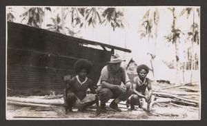 [Squatting in Front of Shed, #1]