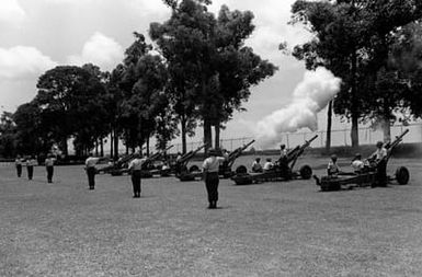 Members of Btry. C, 2nd Bn., 11th Field Arty., 25th Inf. Div., Schofield Barracks, fire 105mm howitzers in a 21-gun salute in honor of the soldiers who died for their country