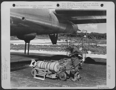 In Preparation For A Bombing Mission Over Tokyo, Japan, An Armorer Moves Bomb Dolly Holding A 500 Lb. Incendiary Bomb Under The Fuselage Of A Boeing B-29 "Superfortress". Isely Field, Saipan, Marianas Islands, November 29, 1944. (U.S. Air Force Number 64299AC)