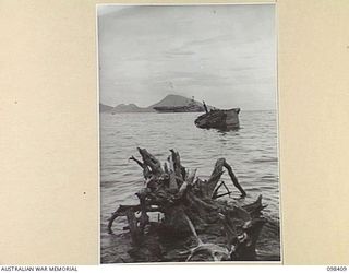 RABAUL, NEW BRITAIN. 1945-10-30. THE ROYAL NAVY AIRCRAFT CARRIER, HMS FORMIDABLE, LEAVING KERAVIA BAY. THE FORMIDABLE EMBARKED OVER 1,000 INDIANS FOR SINGAPORE AND INDIA