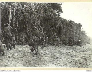 DANMAP RIVER AREA, NEW GUINEA. 1945-01-02. TROOPS OF A COMPANY, 2/11TH INFANTRY BATTALION, MAKE FOR THE JUNGLE COVER AFTER CROSSING THE RIVER DURING THEIR ADVANCE ON JAPANESE POSITIONS. IDENTIFIED ..