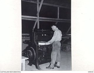 RABAUL, NEW BRITAIN, 1946-03-27. SERGEANT C. SIMPSON, OPERATING THE GUILLOTINE DURING PRODUCTION OF THE ARMY NEWSPAPER GUINEA GOLD. THE NEWSPAPER CHANGED ITS LOCATION FROM LAE TO 8 MILITARY ..