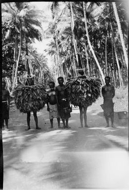 Two Dukduks with onlookers, Matupit, Rabaul Harbour, New Guinea, 1929, 2 / Sarah Chinnery