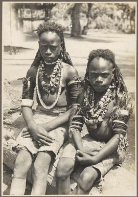 Ambasi types [two seated girls wearing necklaces and armbands] Frank Hurley