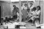 Christian women in a kitchen with walls of iron roofing