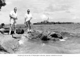 Lauren R. Donaldson, left, and Ralph F. Palumbo standing on the lagoon beach of Eniwetok Island, summer 1964