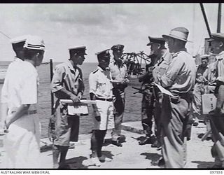 OCEAN ISLAND. 1945-09-30. MEMBERS OF THE RECONNAISSANCE PARTY FROM HMAS DIAMANTINA WHO WERE FIRST ASHORE, QUESTIONING JAPANESE OFFICERS AT THE BOAT HARBOUR. BRIGADIER J. R. STEVENSON AND PARTY ARE ..