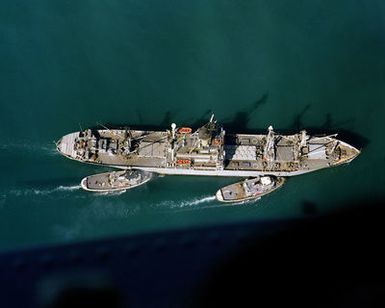 Harbor tugs position the cable transport ship USNS FURMAN (T-AK 280)