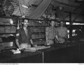 LAE, NEW GUINEA. 1944-09-22. THE INTERIOR OF THE OFFICERS' SHOP, HEADQUARTERS NEW GUINEA FORCE. IDENTIFIED PERSONNEL ARE:- VX75547 CORPORAL C.E. RODER (1); VX73565 CORPORAL H.S. WATSON (2); VX58950 ..