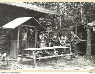 PERSONNEL OF NO. 5 PLATOON (PIONEERS), HEADQUARTERS COMPANY, 27TH INFANTRY BATTALION MAKING A SENTRY BOX AND A MESS TABLE IN THE UNIT WORKSHOP. IDENTIFIED PERSONNEL ARE:- S20721 PRIVATE J.S. OLDS ..