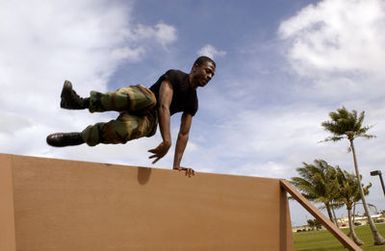 U.S. Air Force 36th Communications Squadron SENIOR AIRMAN Christopher Berry jumps over a wall during Warrior Challenge Day at Arc Light Memorial Park, Andersen Air Force Base, Guam, on Jan. 14, 2005. (U.S. Air Force PHOTO by AIRMAN Teresa M. Pumphrey) (Released)