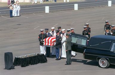 A joint services casket team removes the casket of the Unknown Serviceman of the Vietnam Era from a hearse for a designation and departure ceremony. After the ceremony the Unknown will be placed aboard the frigate USS BREWTON (FF 1086) for transport to Naval Air Station, Alameda, California