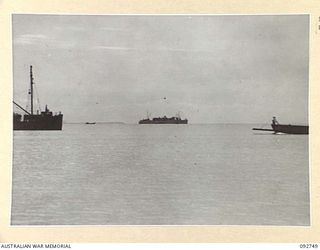 WEWAK AREA, NEW GUINEA. 1945-05-30. A LONG SHOT OF SS TAROONA WITH SOME OF THE SMALL CRAFT IN WEWAK HARBOUR JUST AFTER THE SHIP HAD DROPPED ANCHOR. THE SHIP, FORMERLY OF THE INTERSTATE PASSENGER ..