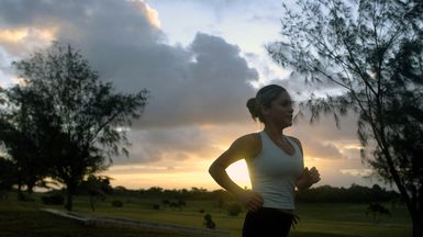 A female runner participates in a 5K run during the Team Andersen Challenge at Andersen Air Base, Guam, on Feb. 25, 2005. U.S. Air Force Airmen from the 13th Air Force and 36th Air Expeditionary Wing, and U.S. Navy Sailors from Helicopter Combat Support Squadron 5 (HC-5), also particpated in the event. (U.S. Air Force PHOTO by STAFF SGT. Bennie J. Davis III) (Released)