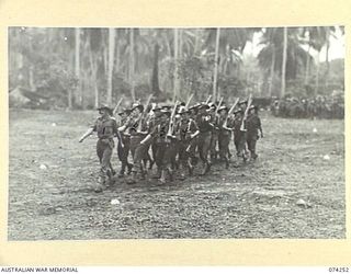 SIAR, NEW GUINEA. 1944-06-23. PERSONNEL OF NO.16 PLATOON D COMPANY, 57/60TH INFANTRY BATTALION MOVING OFF THE UNIT PARADE GROUND AT THE CONCLUSION OF THE MORNING PARADE. IDENTIFIED PERSONNEL ARE:- ..