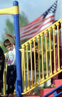 Evacuated Kurdish children play in the playground at their temporary housing at Andersen Air Force Base, Guam, during Operation Pacific Haven. The operation, a joint humanitarian effort conducted by the U.S. Military, evacuated over 2,100 Kurds from northern Iraq. The evacuees will be housed temporarily at Andersen AFB, Guam, while they go through the immigration process for residence into the United States