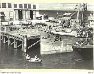 PORT MORESBY, PAPUA. 1944-08-12. THE RAN WORK JETTY. SHOWING IN THE LEFT FOREGROUND IS ONE OF THE WORKSHOPS