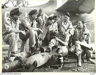 1943-07-16. NEW GUINEA. SOME OF THE PILOTS WHO PARTICIPATED IN THE LARGEST BOMBING RAID ON A LAND TARGET IN THE SOUTHWEST PACIFIC AREA. LEFT TO RIGHT. F/O AUSTIN SKINNER, OF WONTHAGGI, VIC., F/LT. ..