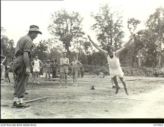 Torokina, Bougainville. 1945-01-01. Sergeant J.A.R. Conley competing in the standing broad jump at an athletic meeting organised by 3rd Australian Army Division Headquarters