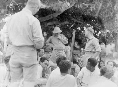 [A gathering of men in uniform and Pacific island people]