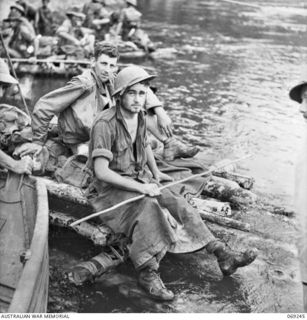 KALIKODOBU, NEW GUINEA. 1942-10. TWO MEMBERS OF THE PARTY OF THE 2/14TH INFANTRY BATTALION RESTING ON THEIR RAFT AFTER 8 HOURS PADDLING DOWN THE RIVER, THESE SOLDIERS WERE MEMBERS OF A PARTY WHICH ..