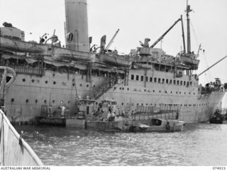 SIAR, NEW GUINEA. 1944-07-25. TROOPS OF THE 61ST INFANTRY BATTALION, DISEMBARKING FROM THE TRANSPORT SHIP (TS) "KATOOMBA" ONTO LANDING BARGES FOR TRANSPORT TO THE BEACH