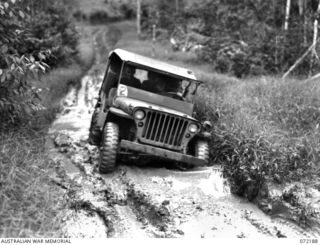 Kokoda Trail, New Guinea. 1944-04-12. A jeep of the 18th Australian Lines of Communication Area Signals negotiating a muddy area between Ilola and Owers' Corner. Jeeps traversed this section daily ..