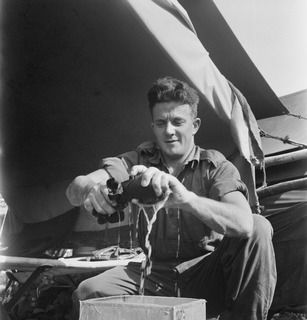 NEW BRITAIN. 1945-05-01. PRIVATE R.A. DOWNIE, BATTALION HEADQUARTERS, 37/52 INFANTRY BATTALION, WASHING HIS CLOTHES ABOARD THE AK82, A VESSEL ON STRENGTH OF THE 16 WATERCRAFT COMPANY, ROYAL ..