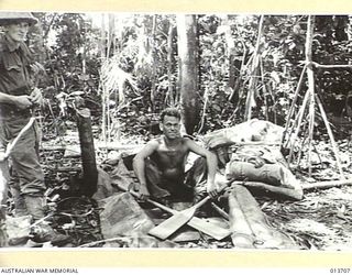 1942-12-01. NEW GUINEA. WAIROPI. JAPANESE TROOPS CAME PREPARED TO CROSS THE RIVER BY BOAT. PET. R.H. FORLAND, N.S.W. SITS IN ONE OF THE JAPANESE RUBBER BOATS LEFT BEHIND WHEN THE JAPANESE ..