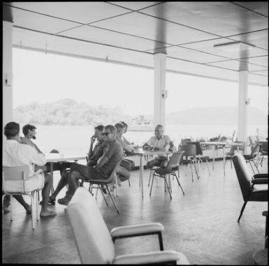 Men seated at tables on a verandah, Port Vila, New Hebrides, 1969 / Michael Terry