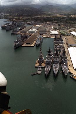 An aerial view of the guided missile cruisers USS JOUETT (CG 29), USS WILLIAM H. STANDLEY (CG 32) and USS GRIDLEY (CG 21), moored to berth K-3 during Exercise RIMPAC '86