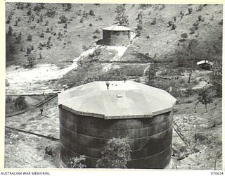 PORT MORESBY, PAPUA, 1944-02-25. "E" AND "G" STORAGE TANKS OF THE BULK OIL INSTALLATIONS AT THE 1ST PETROLEUM STORAGE COMPANY SHOWING THE MAIN CARGO LINES