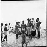 Father Laughman, men, boys, and canoe on shore