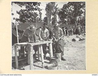 WIRUI BEACH, WEWAK, NEW GUINEA. 1945-09-04. WASHING DAY FOR TROOPS OF 2/11 INFANTRY BATTALION. IDENTIFIED PERSONNEL ARE:- PRIVATE W.W. BURGESS (1); PRIVATE H.A. ANDERTON (2); PRIVATE R.A. BUTLER ..