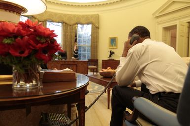 Barack Obama makes a phone call in the Oval Office