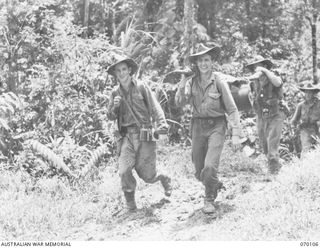 KETOBA, NEW GUINEA. 1944-01-29. NX153290 SIGNALMAN C.L.O. BELL (1); VX141659 SIGNALMAN L.T. KNORPP (2) AND V76017 SIGNALMAN P.J. RYAN (3); OF THE 57/60TH INFANTRY BATTALION FIND HEAVY GOING IN ..