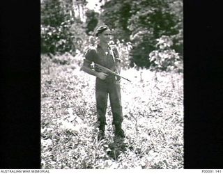 THE SOLOMON ISLANDS, 1945-05. AN AUSTRALIAN SOLDIER WITH OWEN GUN AT NORTH BOUGAINVILLE. (RNZAF OFFICIAL PHOTOGRAPH.)