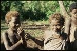 Young boy and girl with necklace of girimalaile clamshell pendants