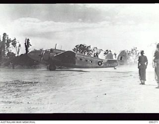 TOROKINA BEACHHEAD, BOUGAINVILLE. 1945-03-30. THE PLANE (AN RAAF LOCKHEED LODESTAR) WITH LORD WAKEHURST, GOVERNOR OF NSW, AND THE OFFICIAL PARTY ON BOARD AS IT TAXIES ON PIVA AIRSTRIP IN ..