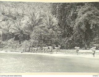 JACQUINOT BAY, NEW BRITAIN. 1944-11-12. THE MORTAR PLATOON SECTION OF THE 14/32ND INFANTRY BATTALION ATTACHED TO B COMPANY, 1ST NEW GUINEA INFANTRY BATTALION SETTING OFF ALONG THE BEACH TO THEIR ..