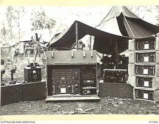 FINSCHHAFEN, NEW GUINEA. 1944-03-27. THE 188F (UNITED STATES ARMY 191F), WIRELESS TRANSMITTER - RECEIVER AT "B" AUSTRALIAN CORPS SIGNALS. FROM LEFT TO RIGHT, THE COMPONENT PARTS COMPRISE THE ..