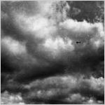 Airplane against large cloud formations, off Honolulu, Hawaii, 1930s