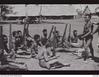 BISIATABU, NEW GUINEA. 1943-07-01. AUSTEN GUN CLASS, C COMPANY, 1ST PAPUAN INFANTRY BATTALION. NATIVE HOLDING AUSTEN MARK 1 SUBMACHINE GUN IS 237 PRIVATE HARIA 2. (NUMBER AFTER NAME DISTINGUISHES ..