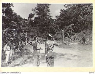NAMANULA, NEW BRITAIN. 1945-10-08. MAJOR GENERAL K.W. EATHER, GENERAL OFFICER COMMANDING 11 DIVISION, ARRIVING AT THE PARADE GROUND FOR AN INSPECTION OF 11 DIVISION SIGNALS