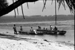 Three canoes gathered at Matalele shore upon return from Saturday morning fishing