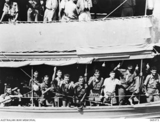 PORT MORESBY, NEW GUINEA. 1942-04-12. SERVICE PERSONNEL OF THE RABAUL GARRISON AND CIVILIANS FROM NEW BRITAIN CROWD THE RAILS OF THE HMAS "LAURABADA" AS THE SHIP DRAWS INTO THE WHARF. THE EVACUEES, ..